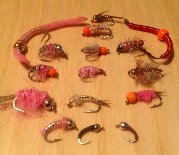 Some of our favorite winter nymph patterns. Top - purple lightning bug. 2nd row Rainbow Weight Fly with firebead. 3rd row left to right pink san juan worm, Rainbow Czech, Firebead Soft Hackle Sow Bug, Keller's Payczech Rainbow. 4th Row Firebead Rainbow Czech, Pink Scud, Tungsten Tailwater Sowbug. 5th row Casne's Pinkalicious, Rainbow Warrior, Firebead Pink Ray. 6th row PInk Lightning Bug, Black Tungsten Zebra Midge, Purple Tungsten Zebra Midge. All available at Wolf Creek Angler. Photo - Wolf Creek Angler
